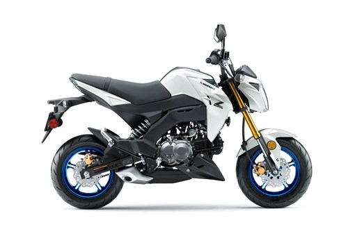 Profile angle of a white motorcycle staged in a white studio background. opens in a new window