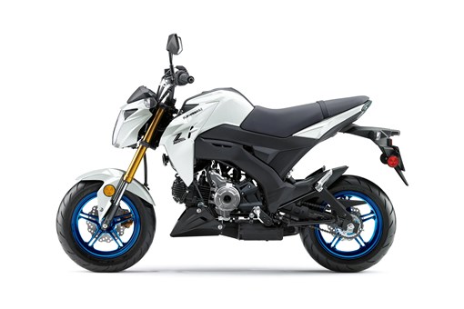 Side angle of a white motorcycle staged in a white studio background. opens in a new window