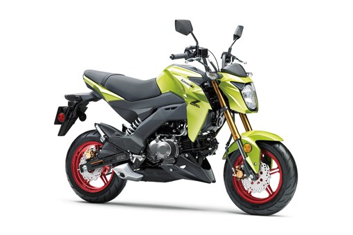 Three-quarter front angle of a green motorcycle staged in a white studio background. opens in a new window