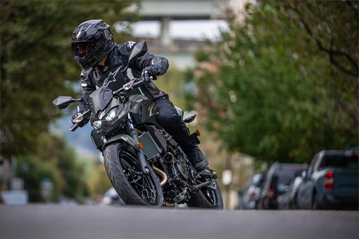 Front angle of a person riding a motorcycle on the street. opens in a new window