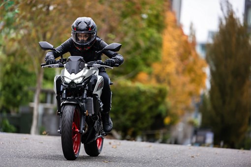 Front angle of a person riding a motorcycle on the street. opens in a new window