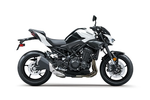 Profile angle of a motorcycle with white accents staged in a white studio background. opens in a new window
