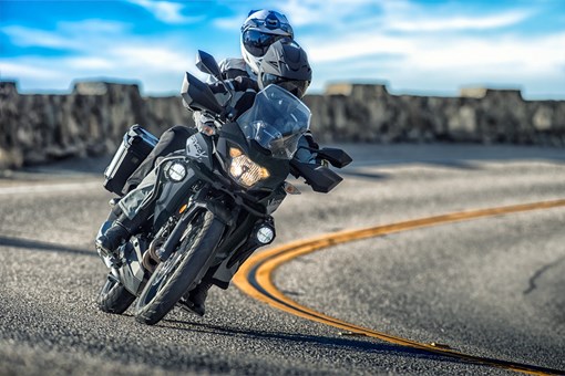 Front angle of a person riding a motorcycle on a highway. opens in a new window