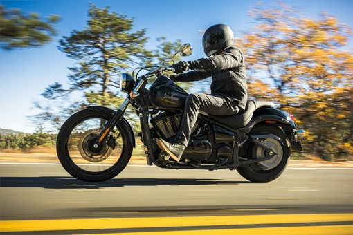 Side angle of a person riding a motorcycle on a highway. opens in a new window