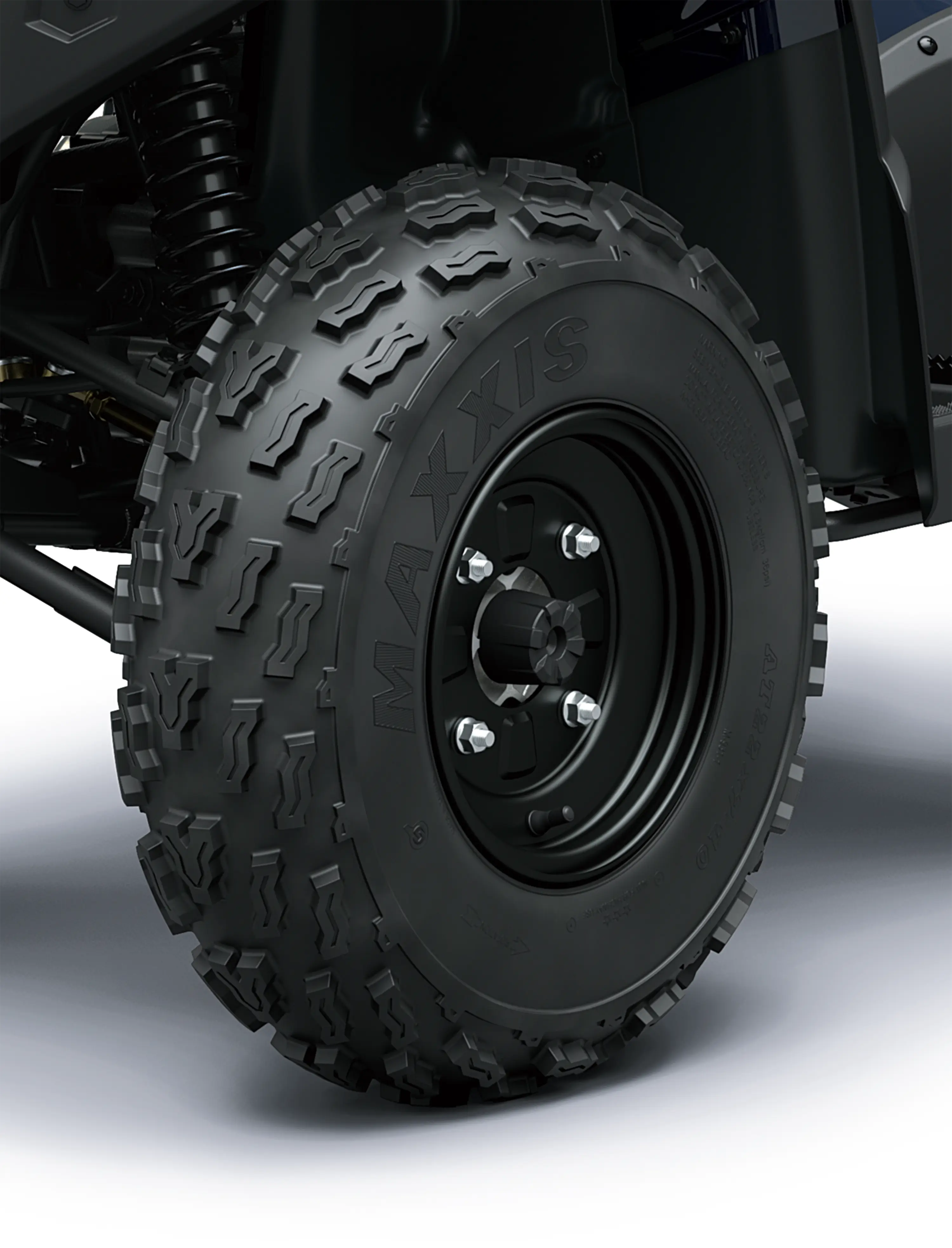 Closeup detail of a wheel of an ATV staged in a white studio background.