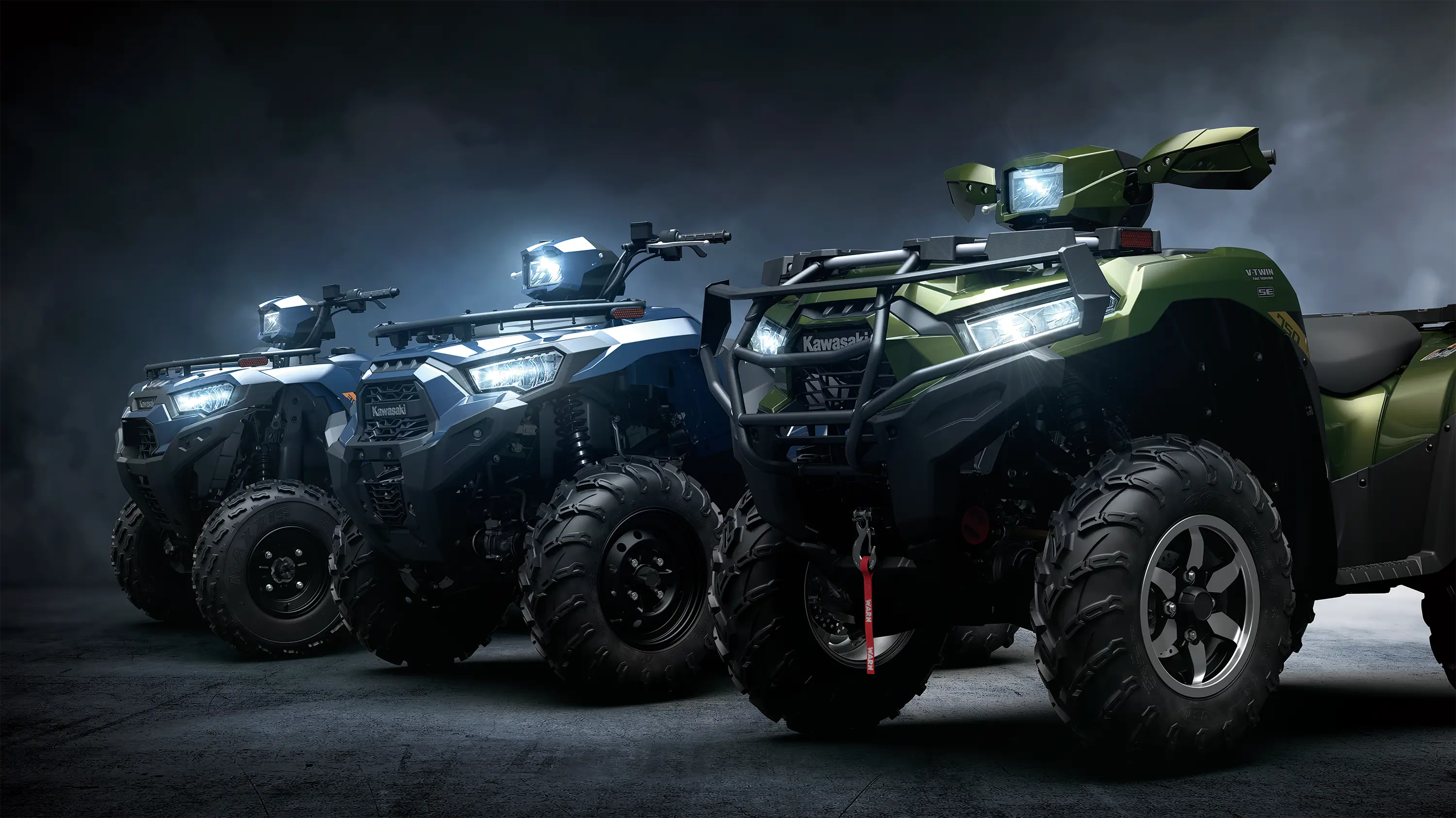 Side angle of 3 ATVs staged in a black studio background.