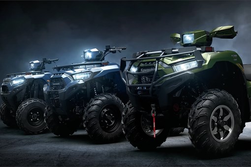 Side angle of 3 ATVs staged in a black studio background. opens in a new window