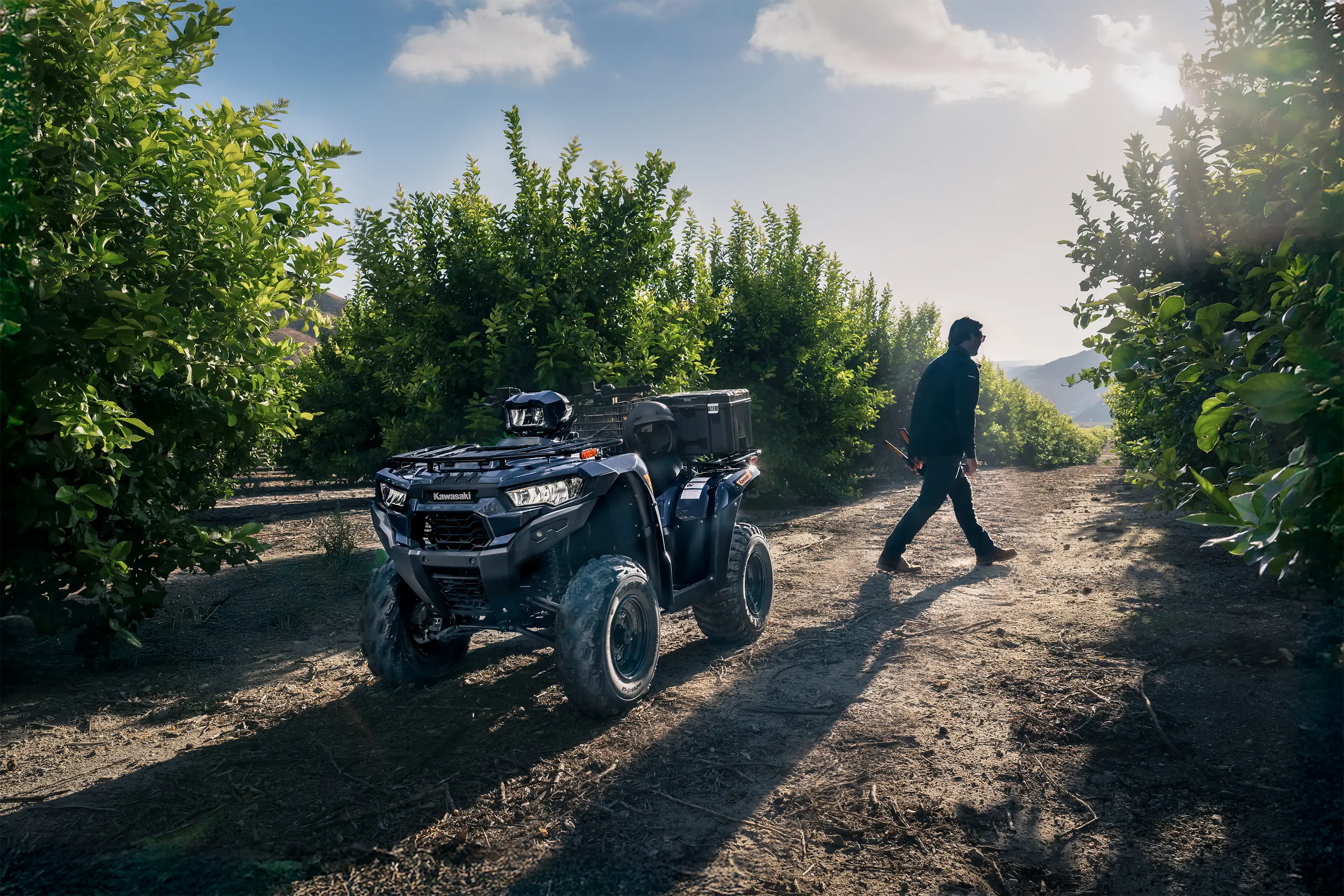 Three-quarter front angle of an ATV parked off-road.