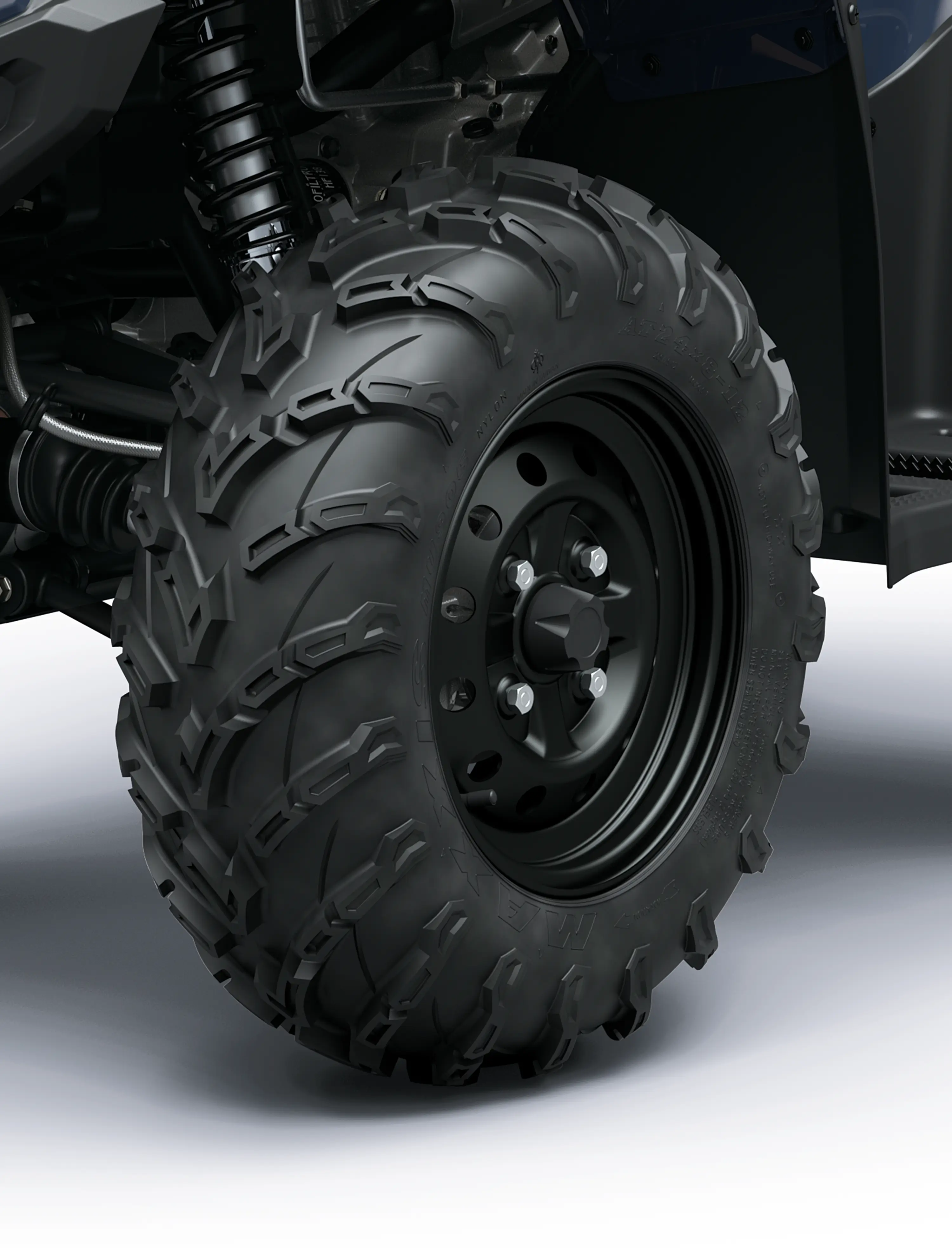 Closeup detail of wheels on an ATV staged in a white studio background.