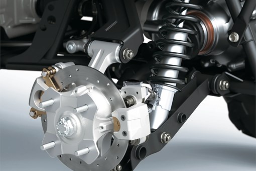 Closeup detail of brakes on an ATV staged in a white studio background. opens in a new window
