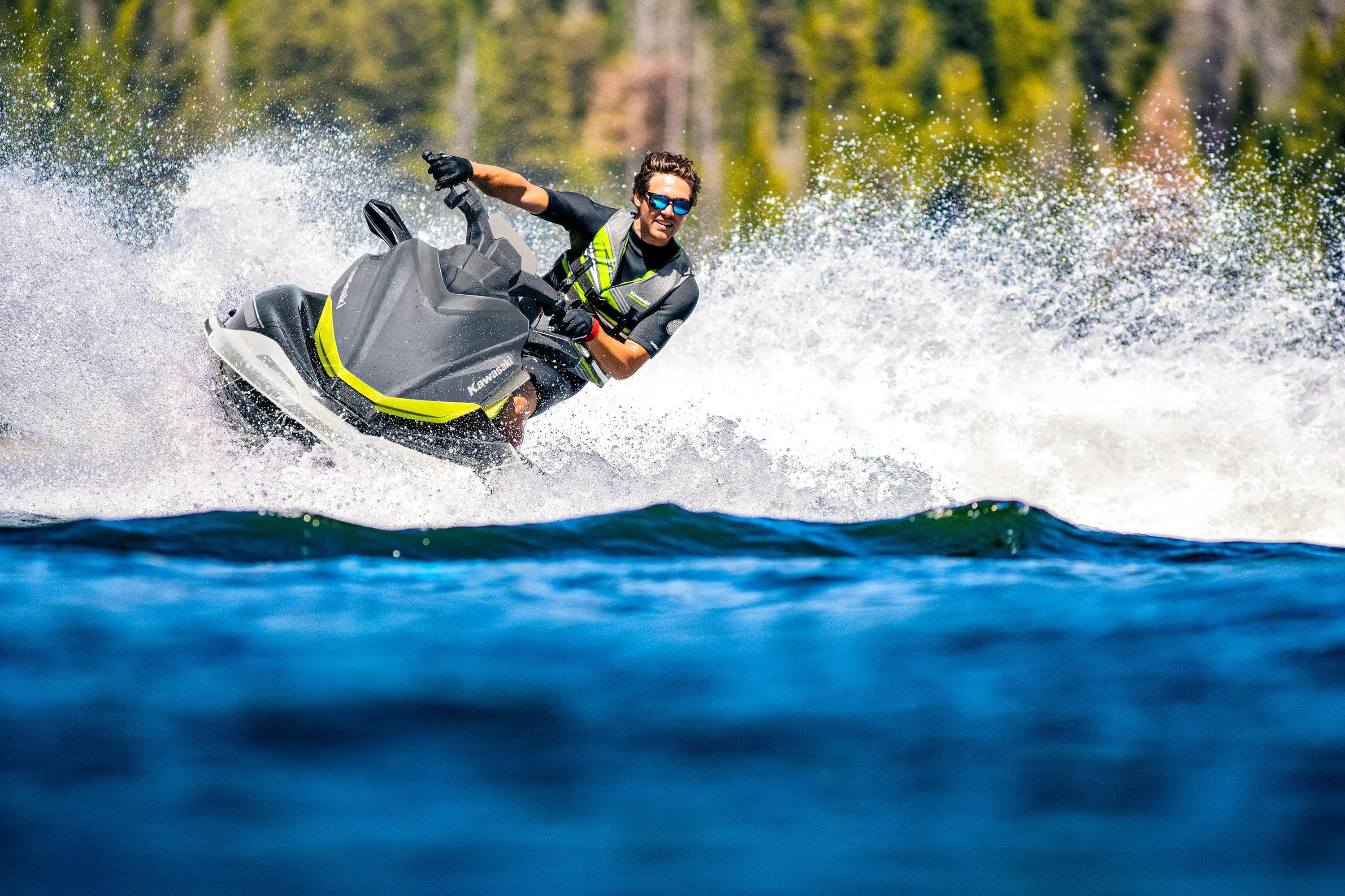 Front angle of a person on a personal watercraft on the water.