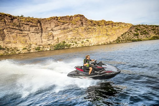 Side overhead angle of a person on a personal watercraft on the water. opens in a new window