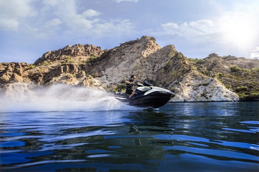 Three-quarter low front angle of a person on a personal watercraft on the water. opens in a new window