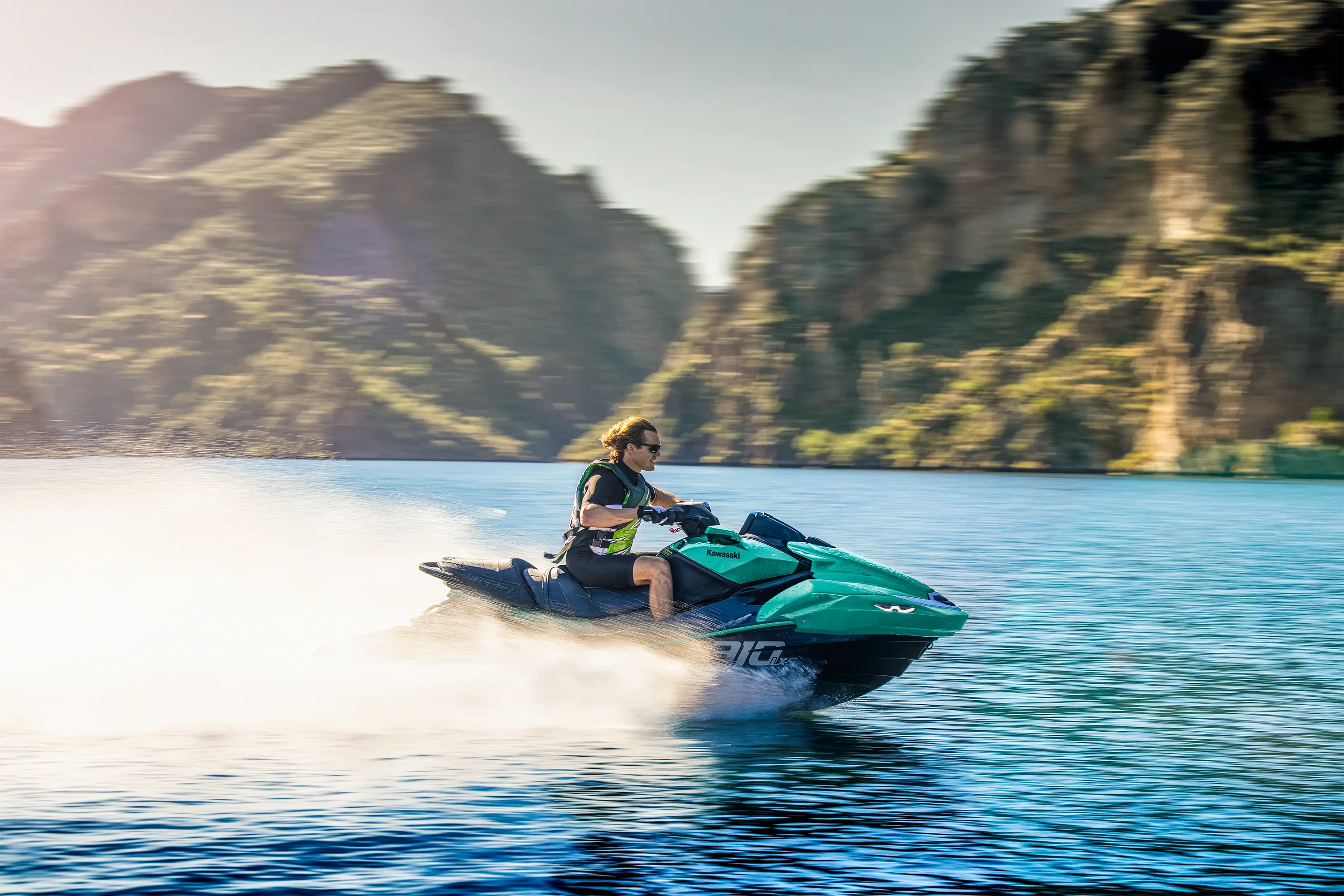 Profile angle of a person on a personal watercraft on the water.