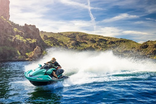 Side angle of a person on a personal watercraft on the water. opens in a new window