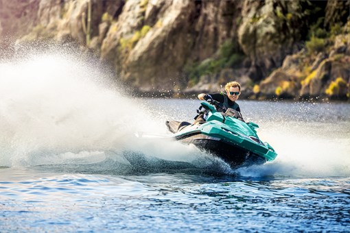 Front three-quarter angle of a person on a personal watercraft on the water. opens in a new window