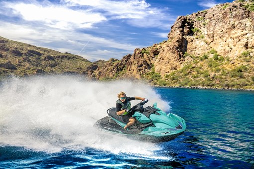 Three-quarter front angle of a person on a personal watercraft on the water. opens in a new window