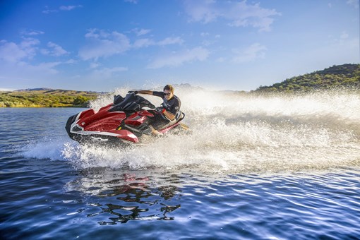 Front three-quarter turning angle of a person on a personal watercraft on the water. opens in a new window
