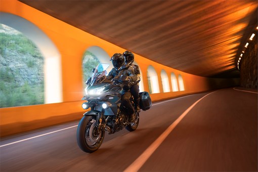 Three-quarter front angle of a person riding a motorcycle in a tunnel. opens in a new window