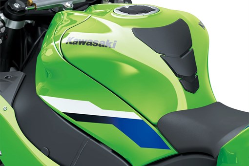 Close-up of the fuel tank of a motorcycle staged in a white studio background. opens in a new window