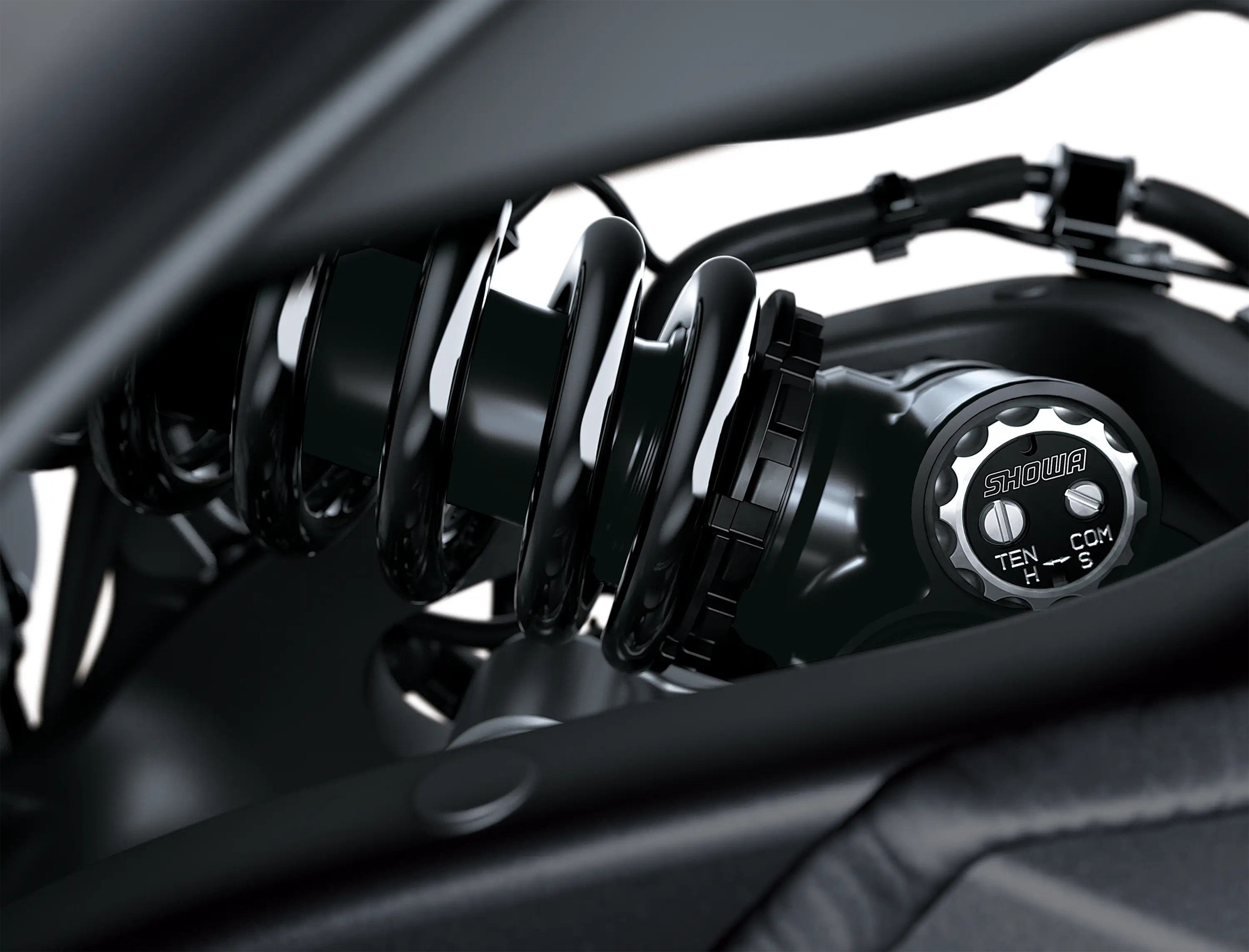 Close-up of the shock of a motorcycle staged in a white studio background.