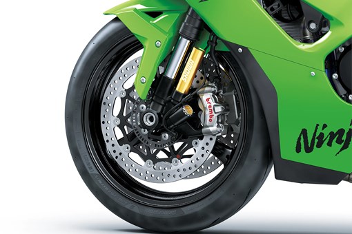 Close-up of the front tire of a motorcycle staged in a white studio background. opens in a new window