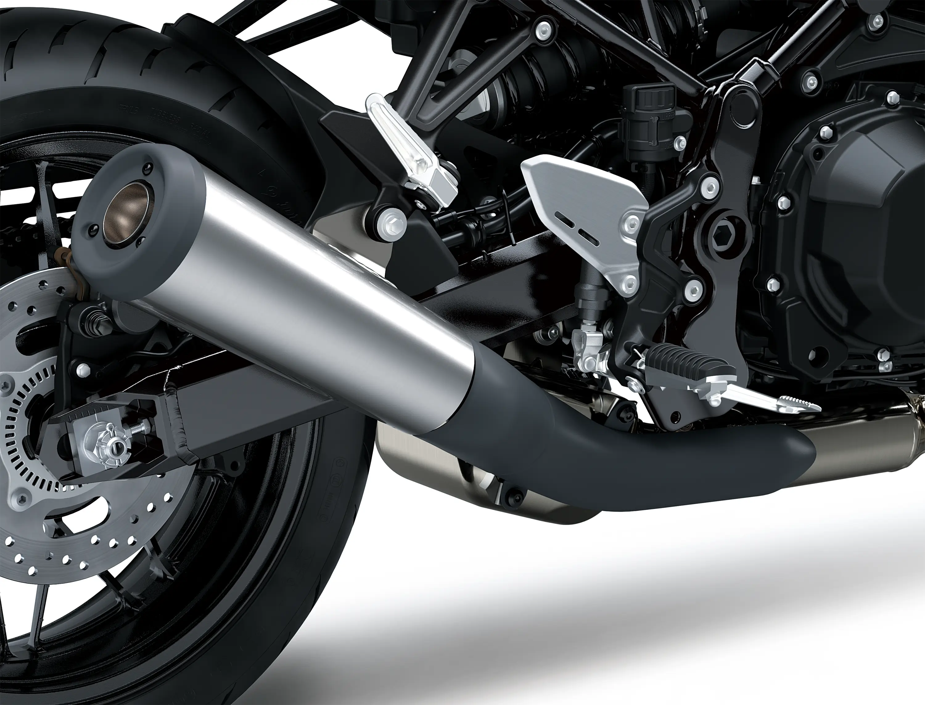 Close-up of the exhaust of a motorcycle staged in a white studio background.