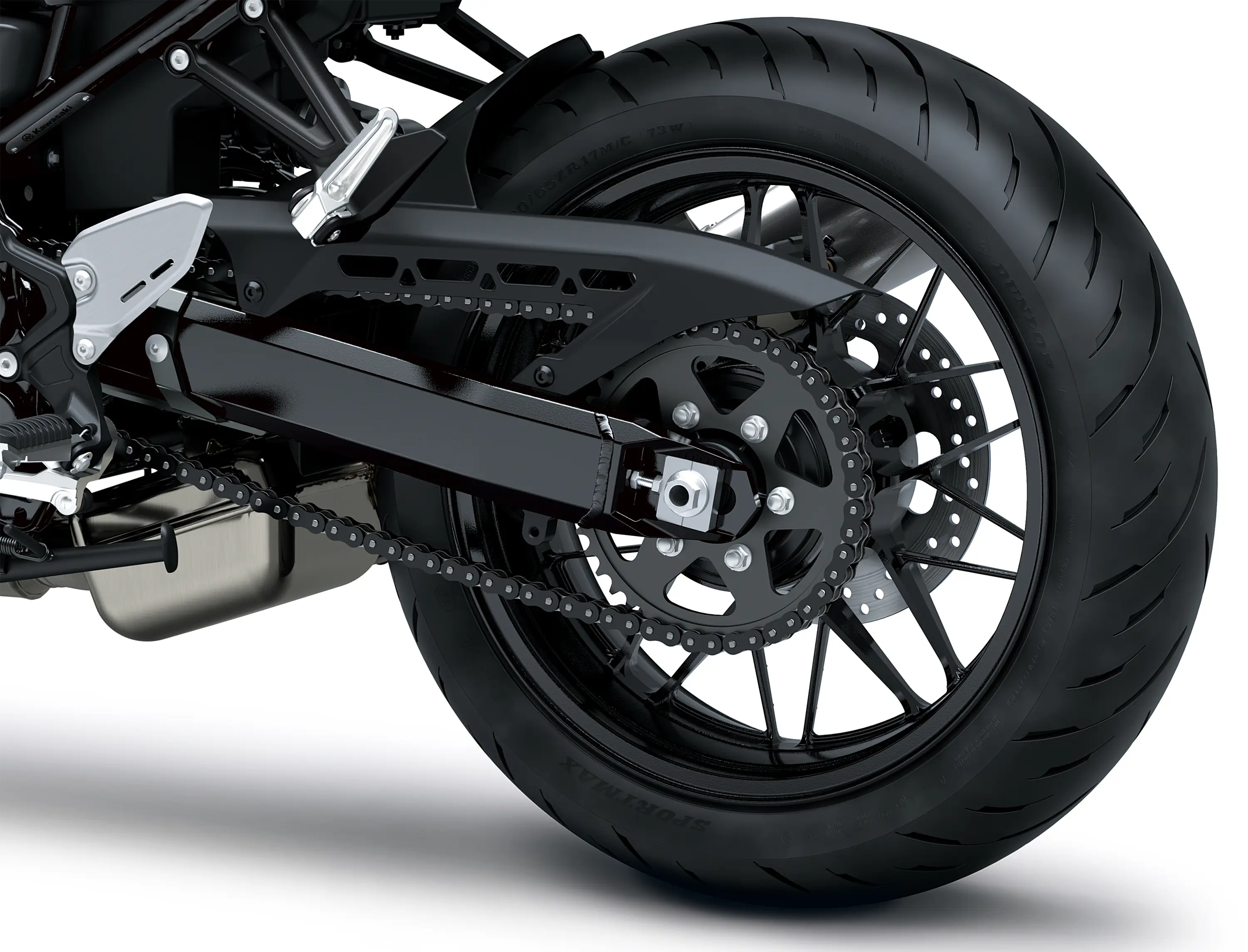 Close-up of the rear tire of a motorcycle staged in a white studio background.