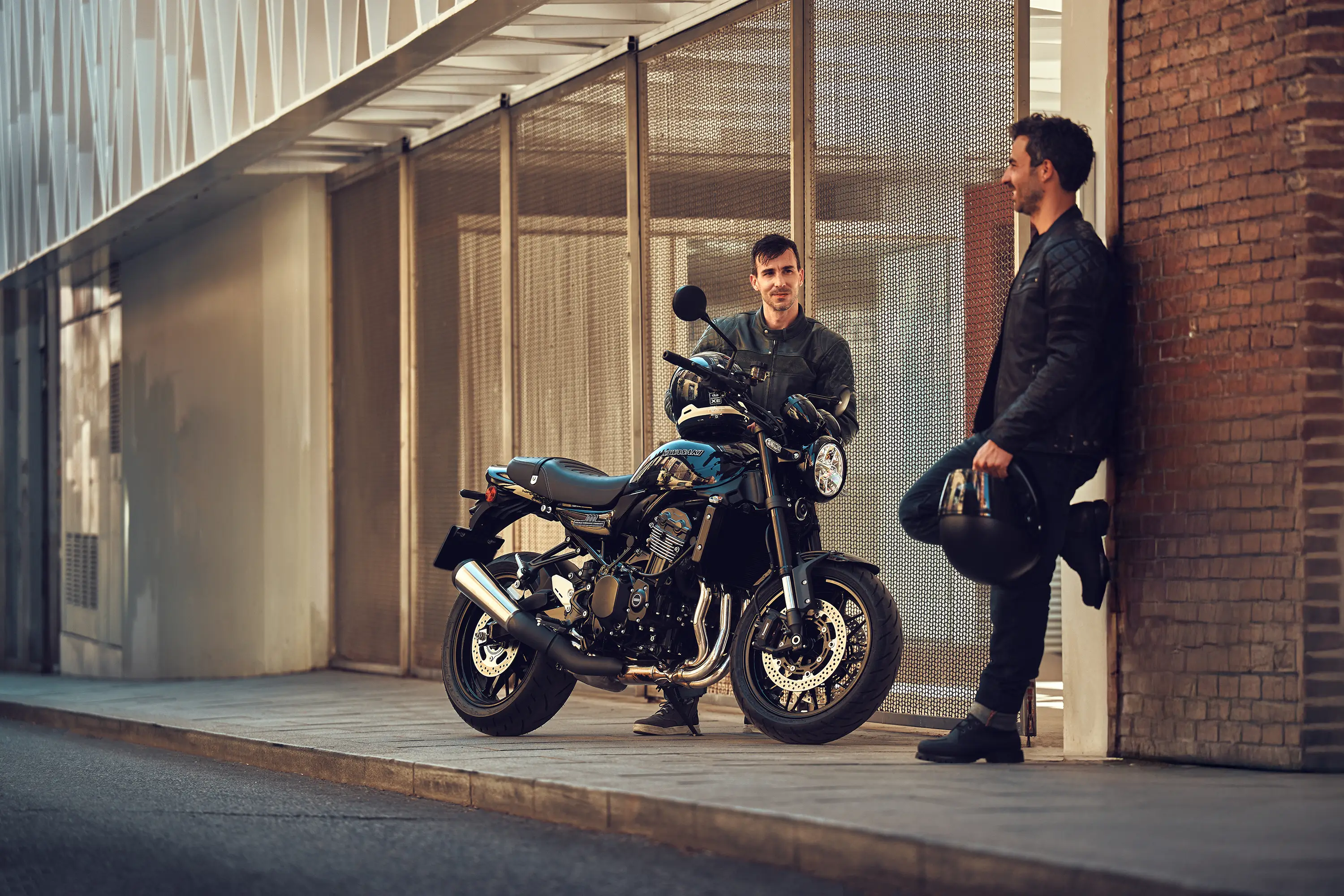 Three-quarter front angle of a motorcycle parked near two people.