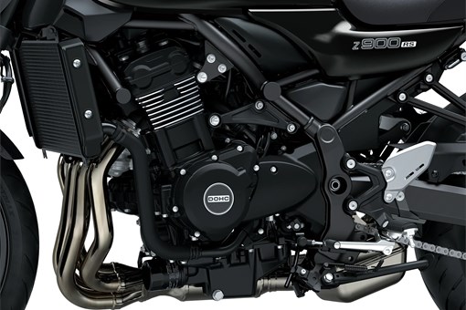 Close-up of the left-side of the engine bay of a motorcycle staged in a white studio background. opens in a new window