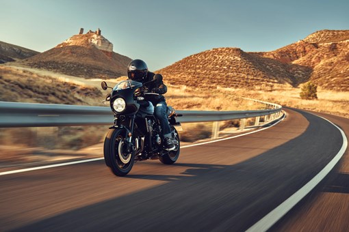 Front angle of a person riding a motorcycle on a highway. opens in a new window