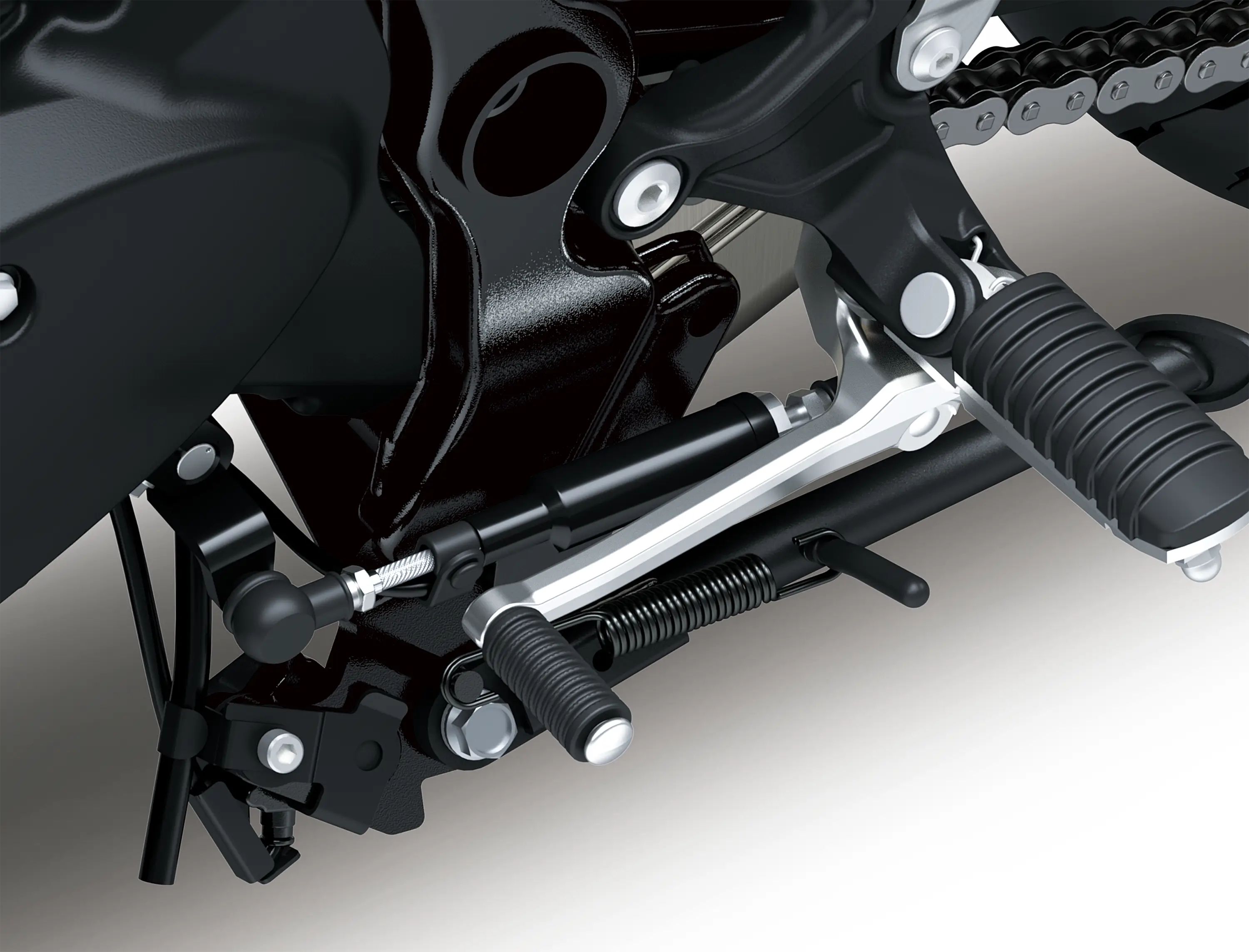 Close-up of the foot peg of a motorcycle staged in a white studio background.