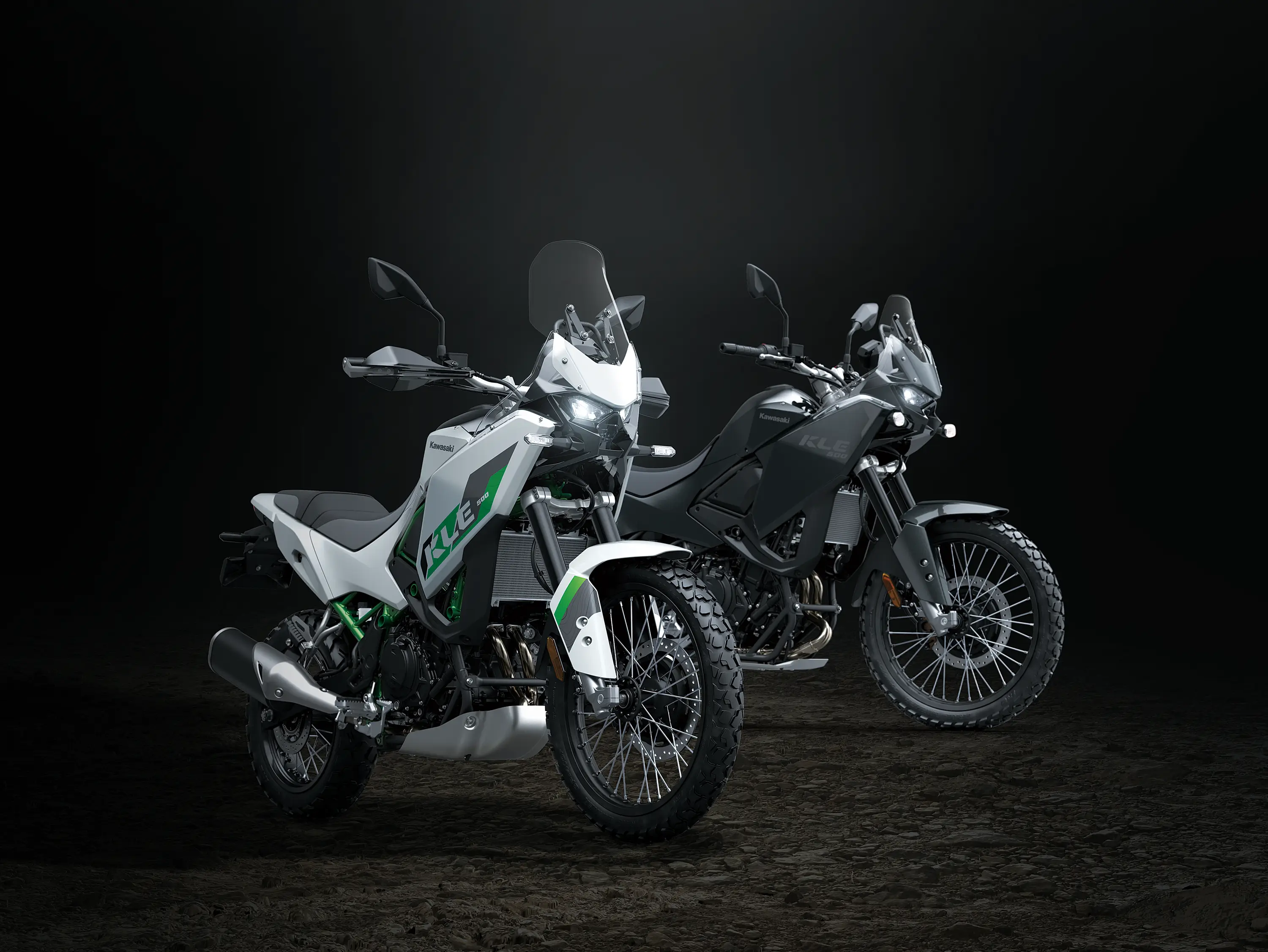 Three-quarter front angle of two motorcycles staged in a black studio background.