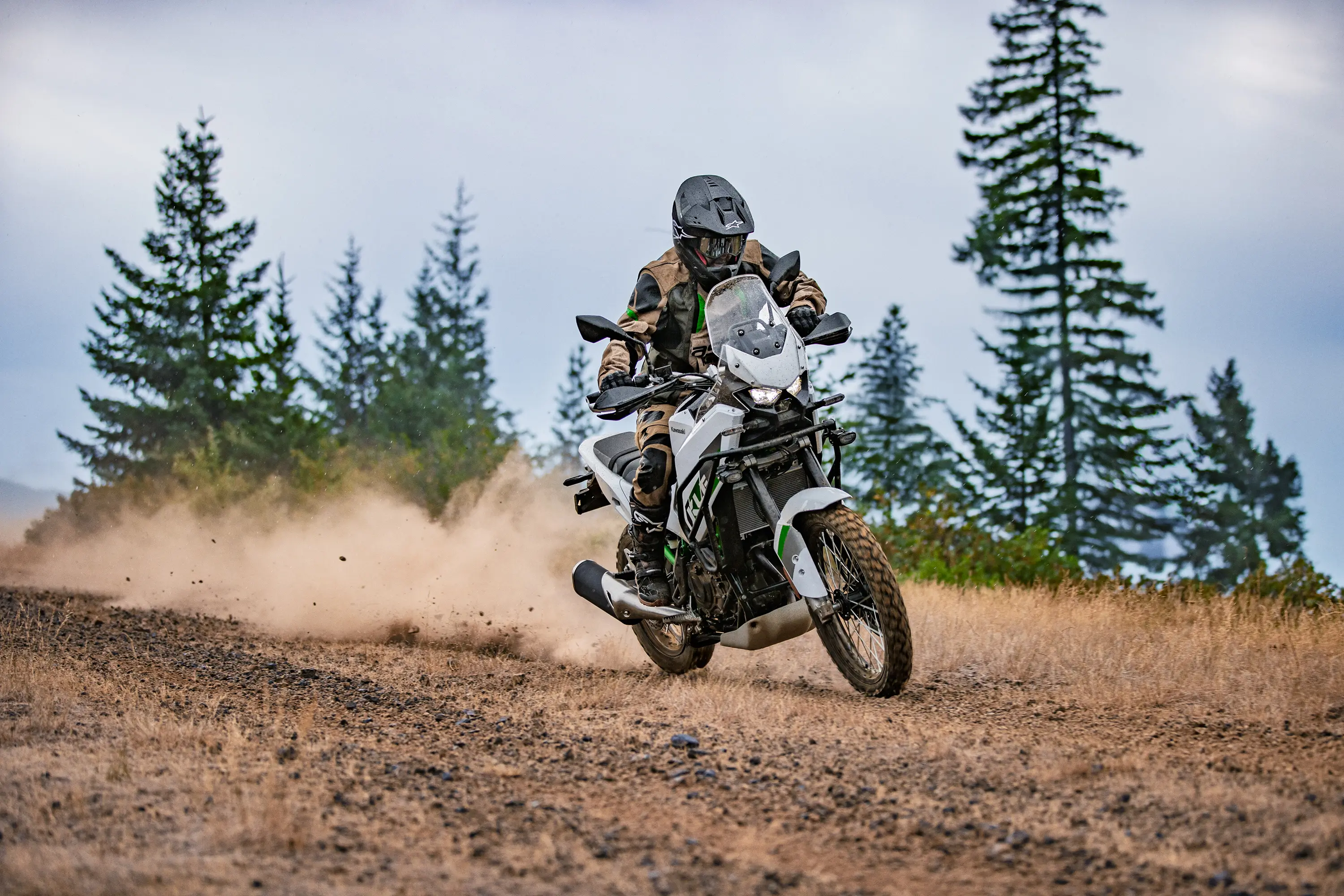 Three-quarter front angle of a person riding a motorcycle off-road.