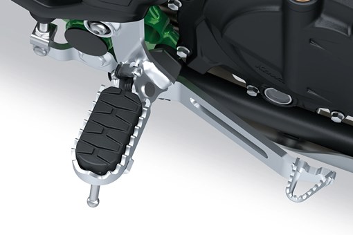 Foot peg of a motorcycle staged in a white studio background. opens in a new window