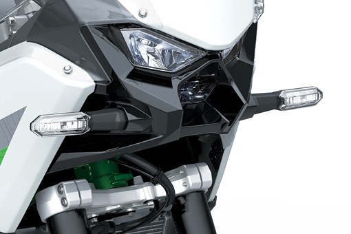 Front close in on headlights of a motorcycle staged in a white studio background. opens in a new window