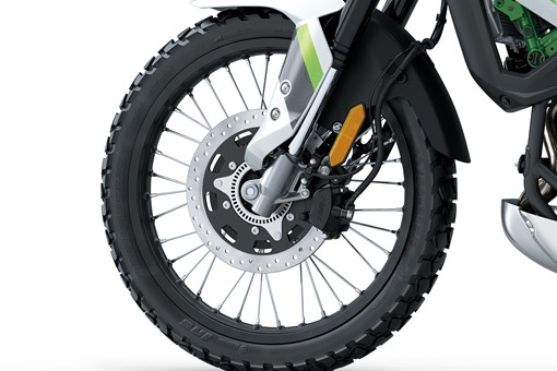 Closeup of a wheel of a motorcycle staged in a white studio background. opens in a new window