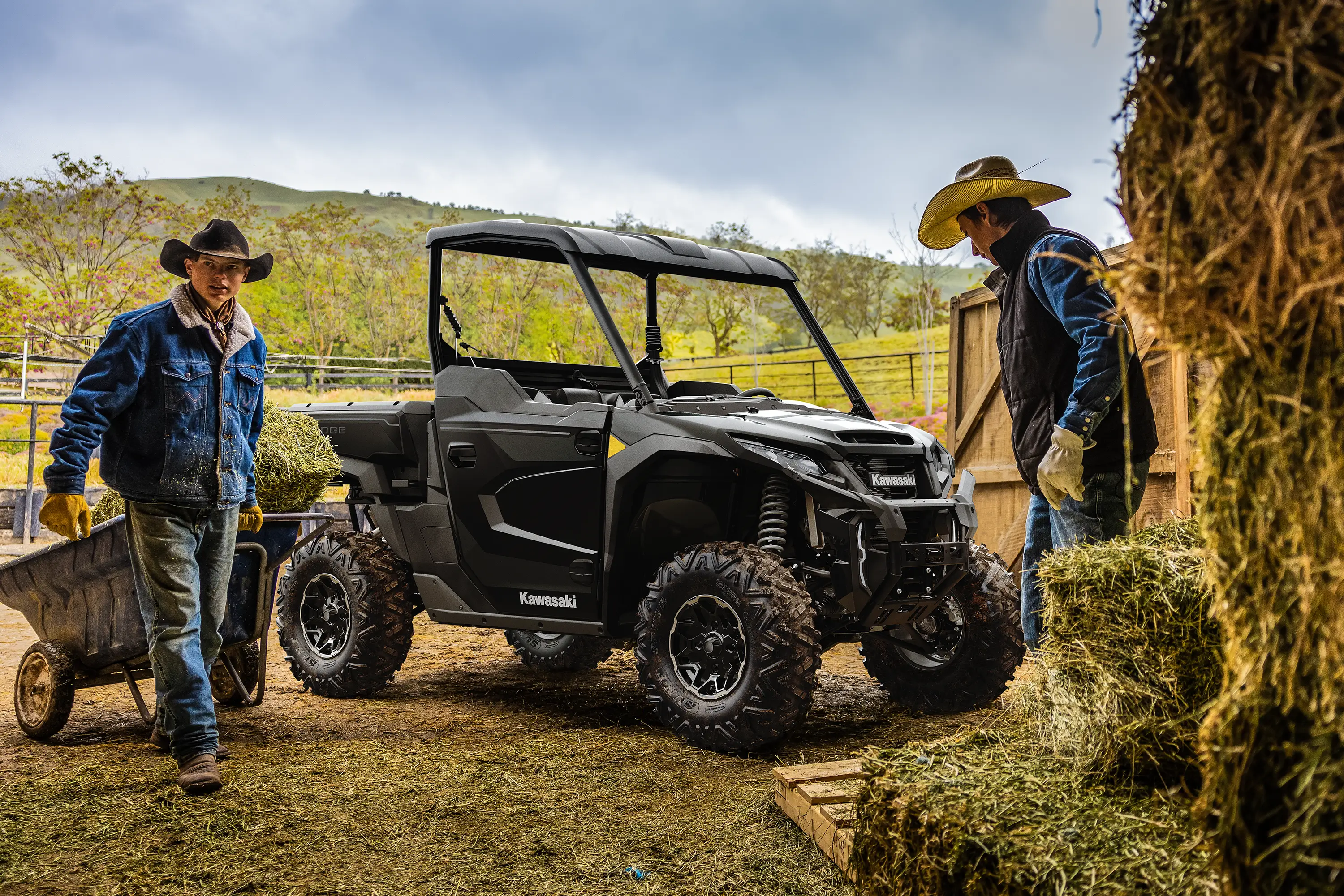 Side angle of a side x side parked near a barn.