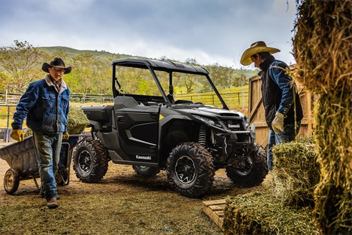 Side angle of a side x side parked near a barn. opens in a new window