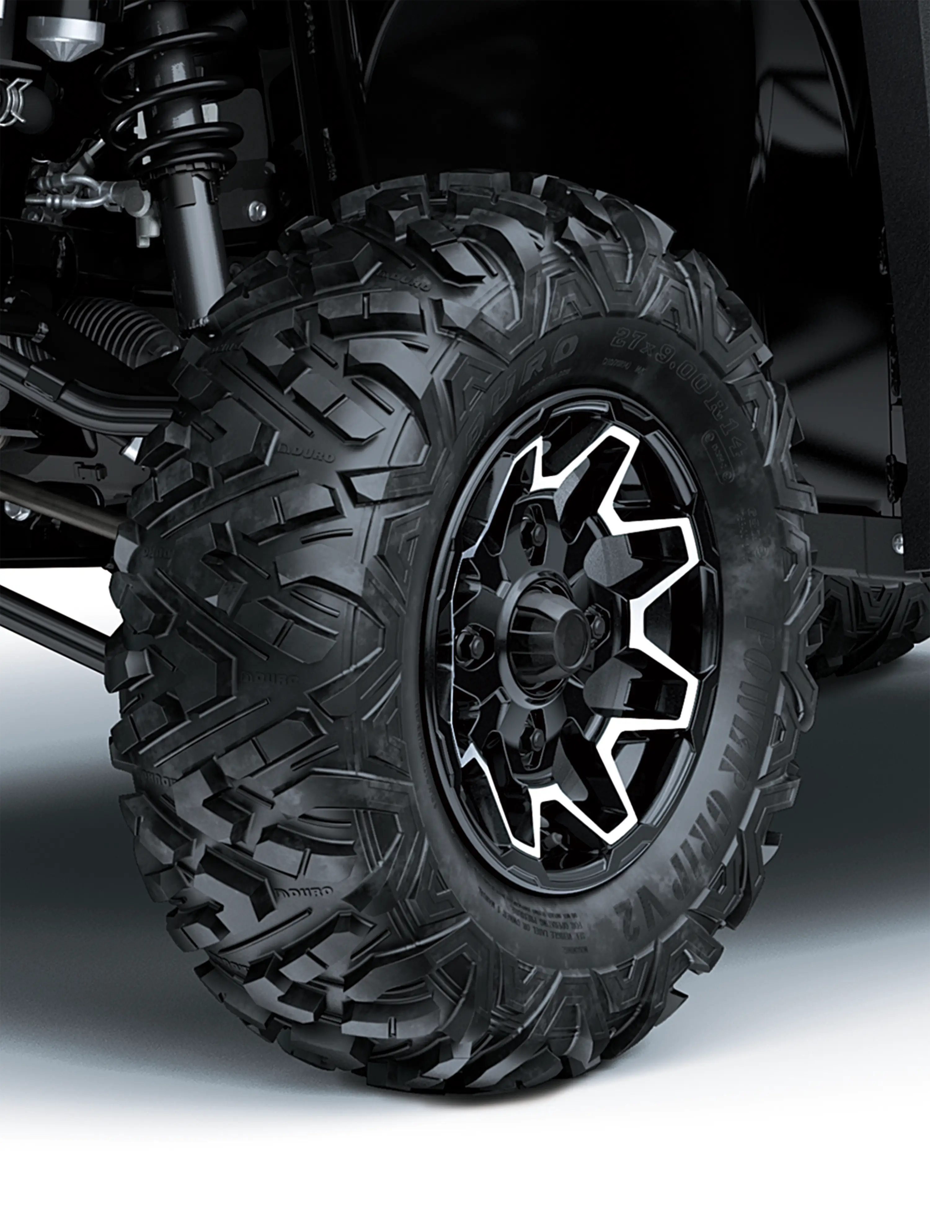 Close-up of a tire of a side x side in a white studio background.