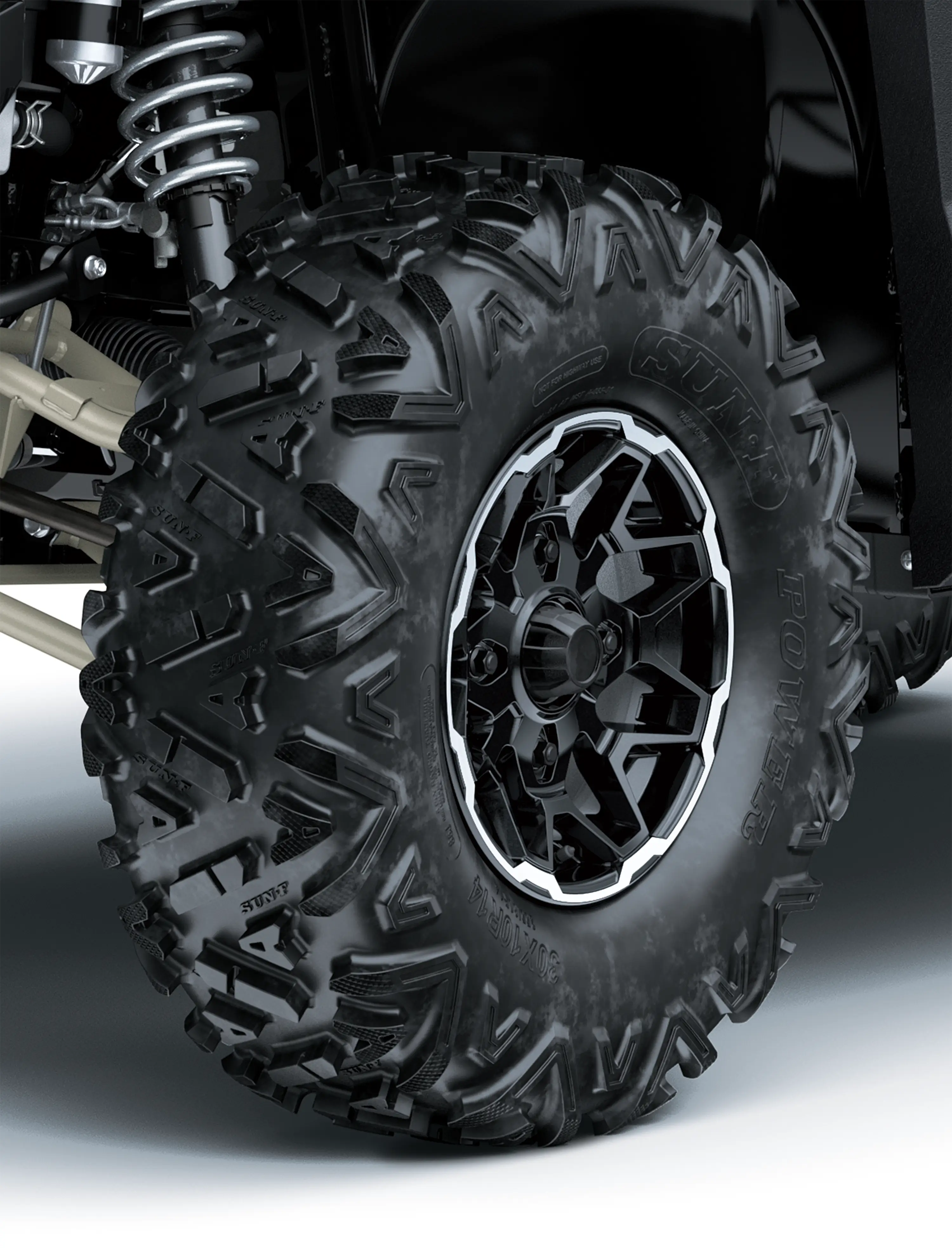 Close-up of a tire of a side x side in a white studio background.