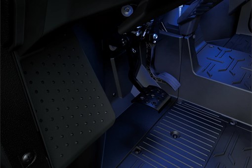 Close-up of the pedals of a side x side. opens in a new window