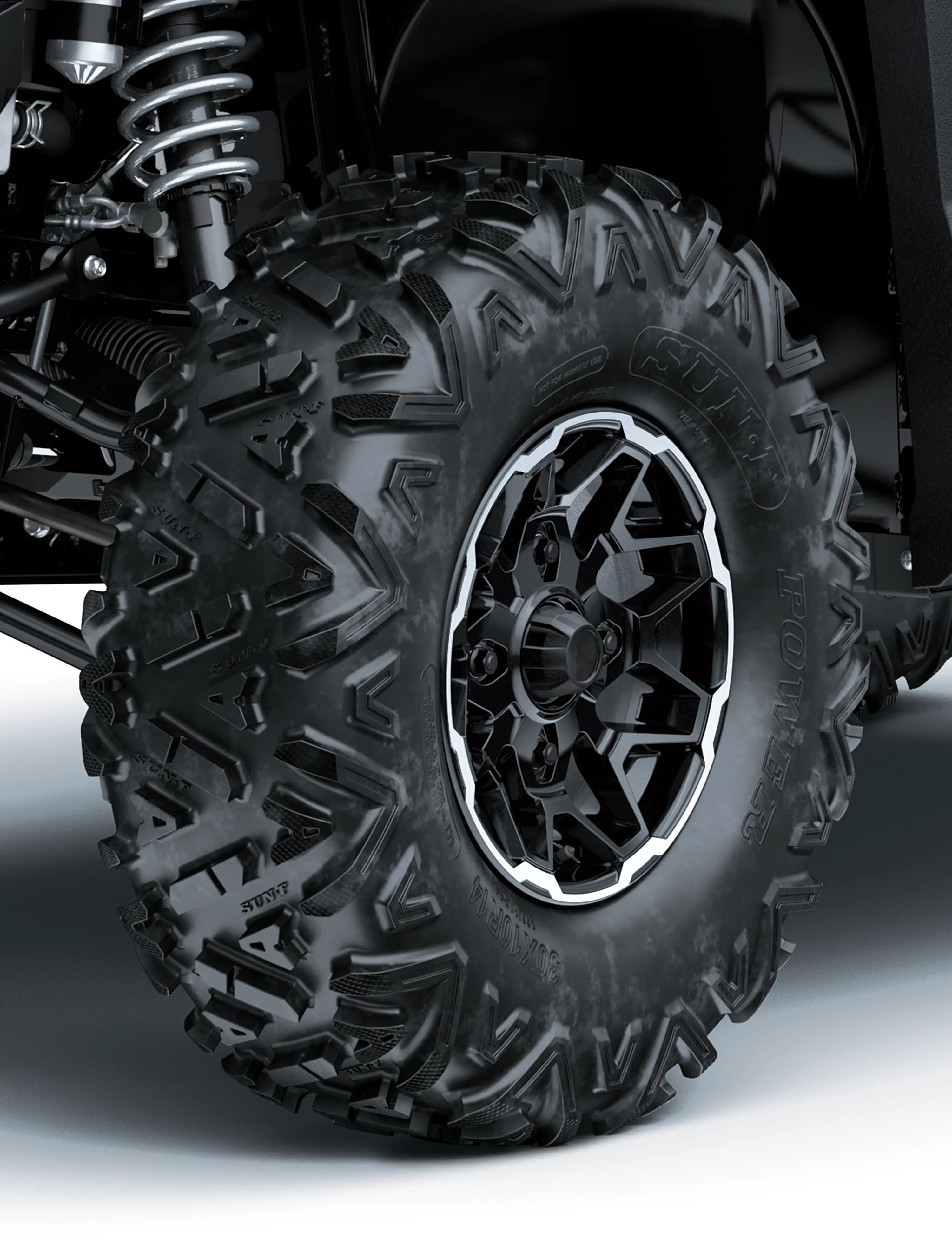 Close-up of a tire of a side x side in a white studio background.