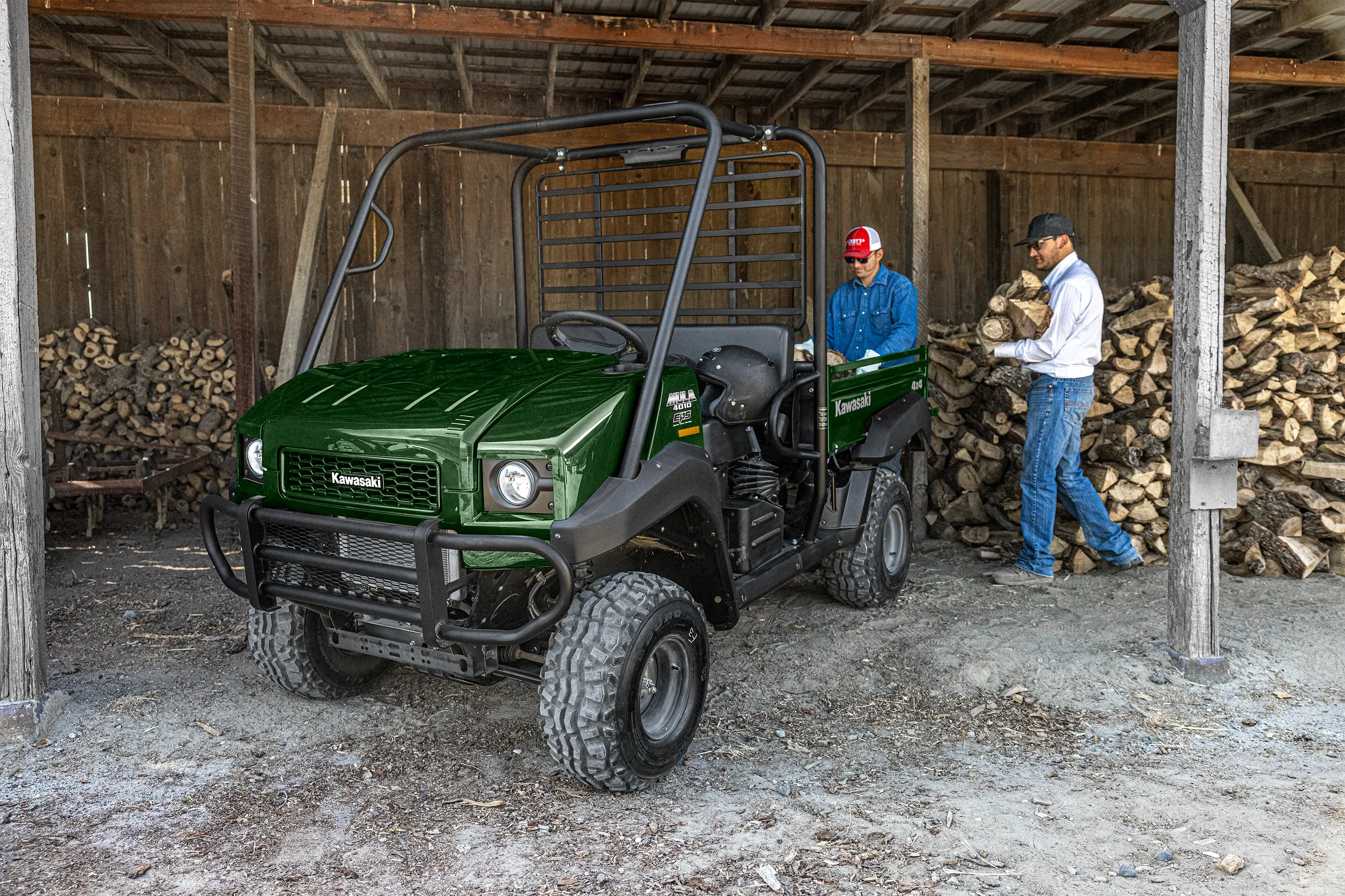 Three-quarter front angle of a side x side parked in a barn.