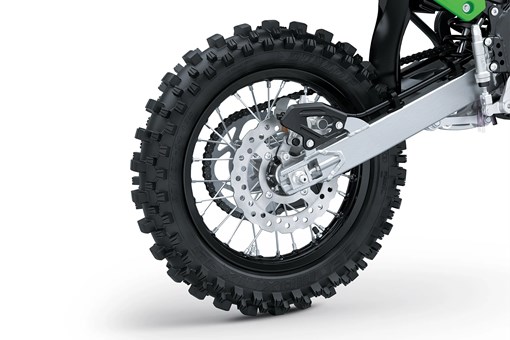 Close up right side view of a dirt bike rear wheel in a white studio background. opens in a new window
