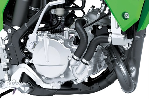Close up right side view of a dirt bike engine in a white studio background. opens in a new window
