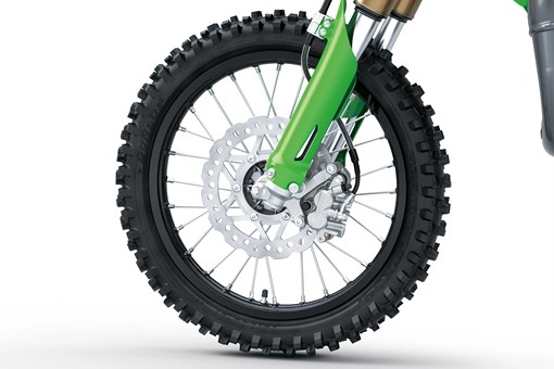 Close up left side view of a dirt bike front wheel in a white studio background. opens in a new window