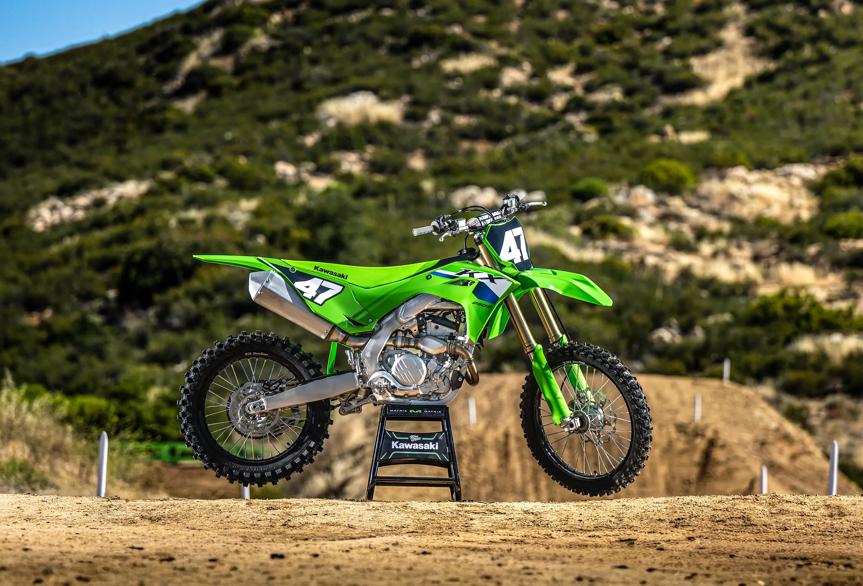 Side angle of a motorcycle staged on a dirt track.