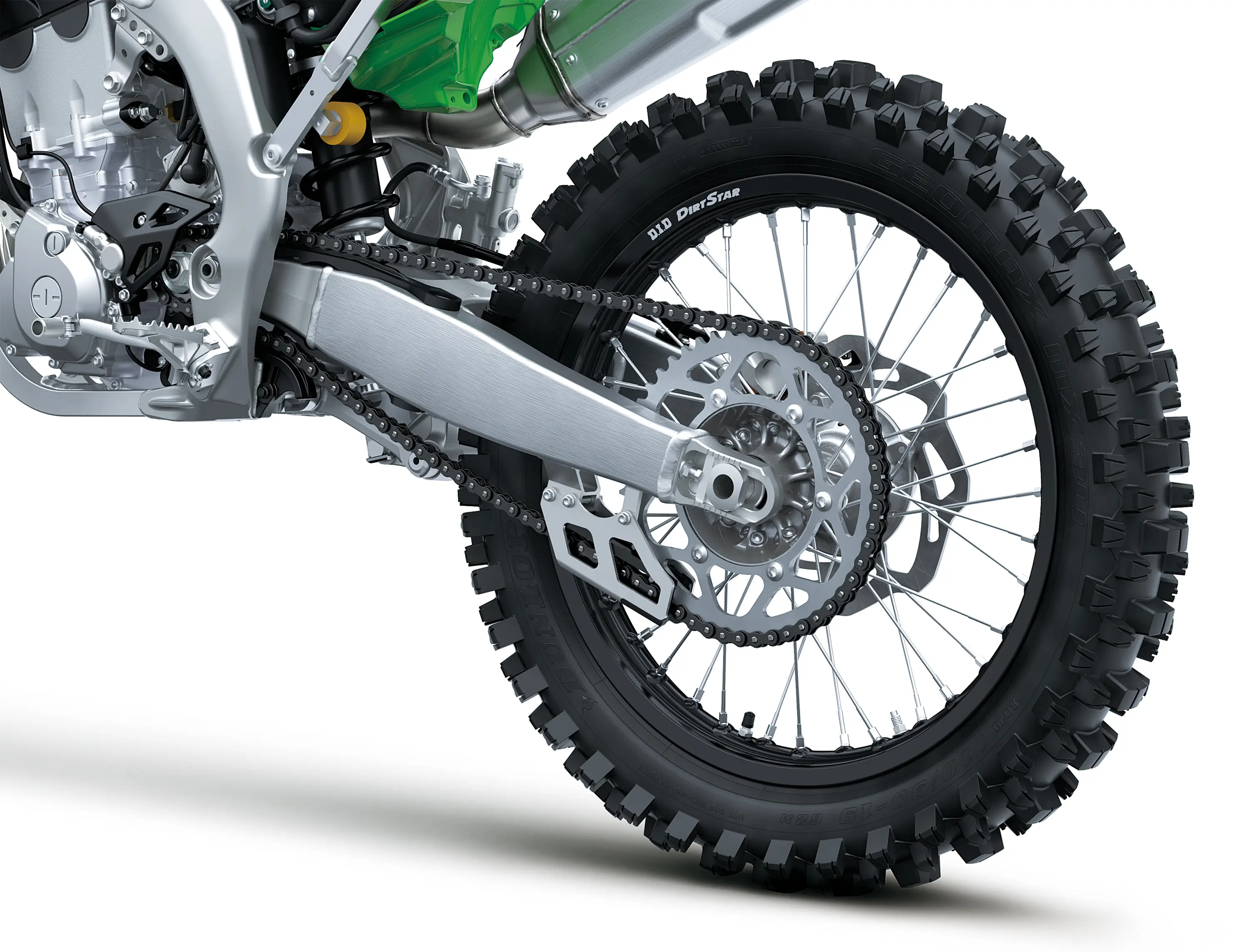 Close-up of the rear wheel of a motorcycle staged in a white studio background.