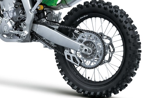 Close-up of the rear wheel of a motorcycle staged in a white studio background. opens in a new window